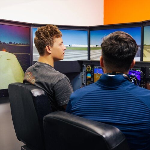 Insuctor and Student On Flight Simulator